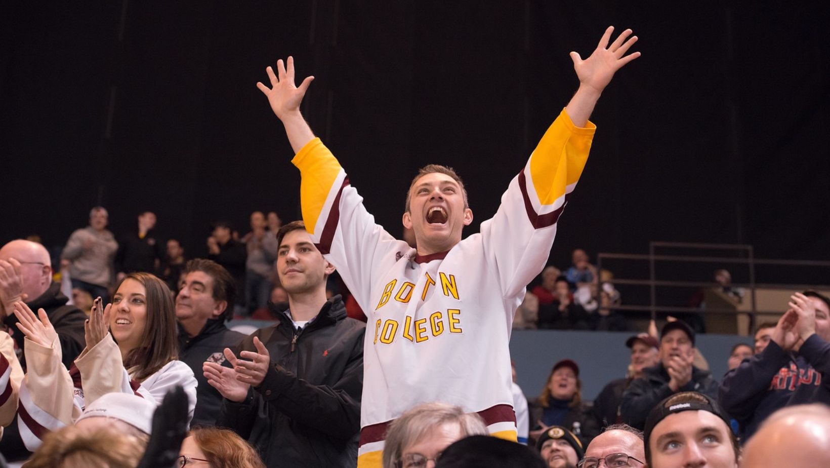 fan cheering while wearing his favorite team uniform