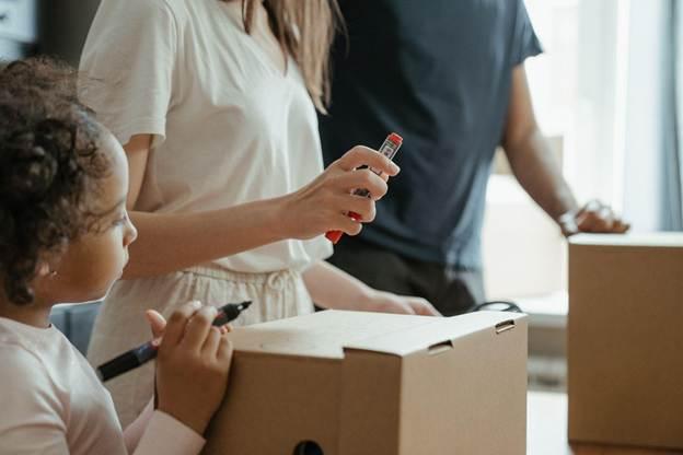 a family packing and thinking about a child's view of moving to a new neighborhood