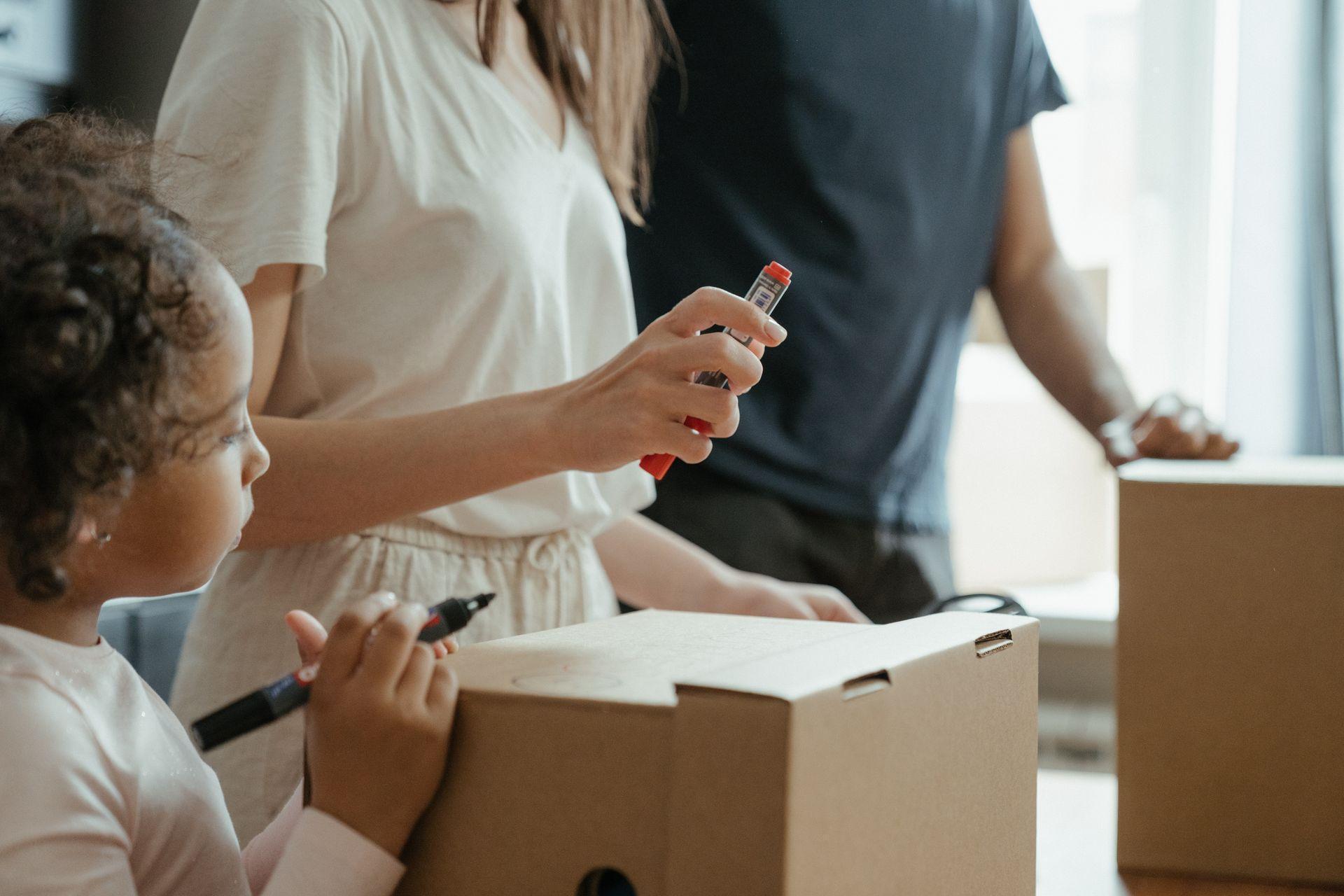 a family packing and thinking about a child's view of moving to a new neighborhood